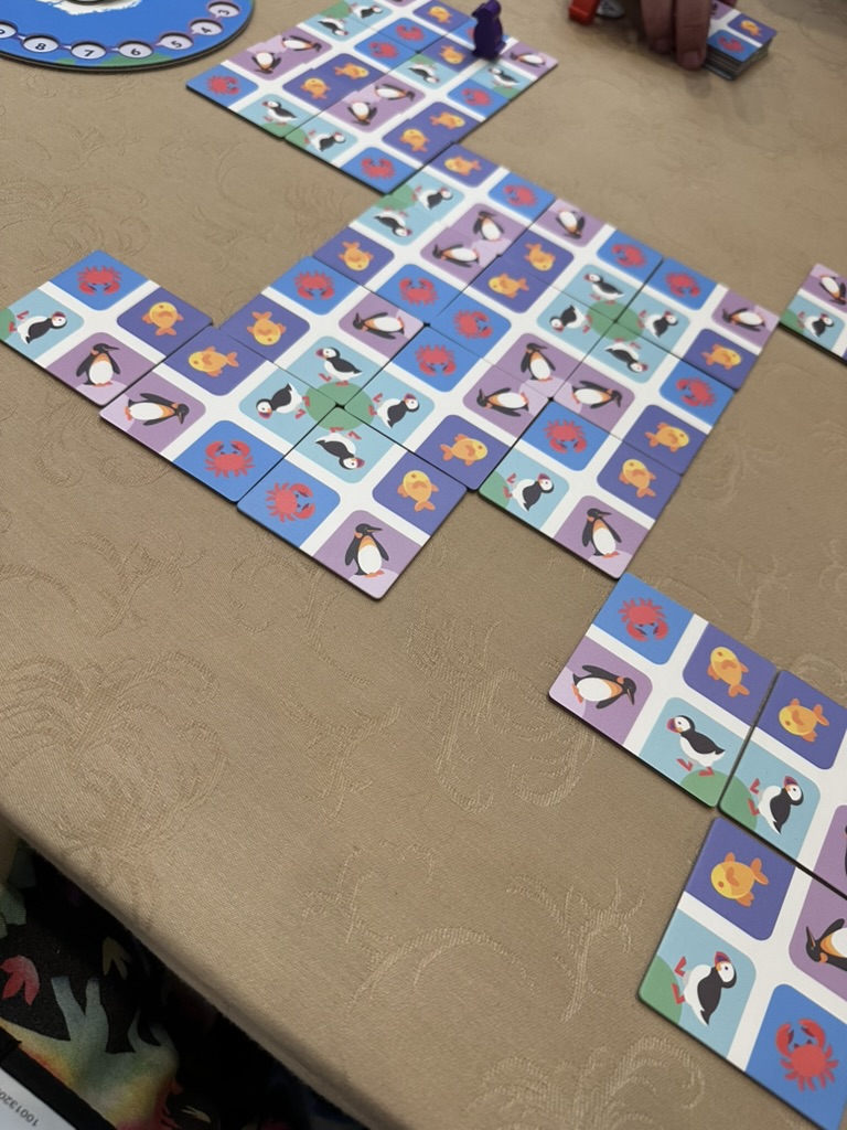 board game with tiles with puffins, penguins, crab, and fish